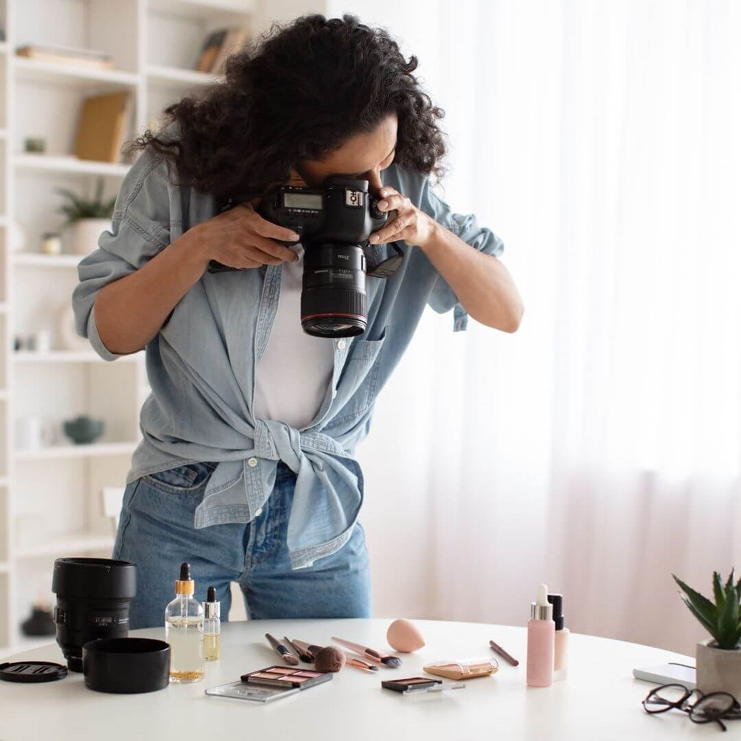 Person taking photos of makeup on a table