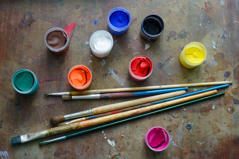 Brushes with tubs of coloured paint