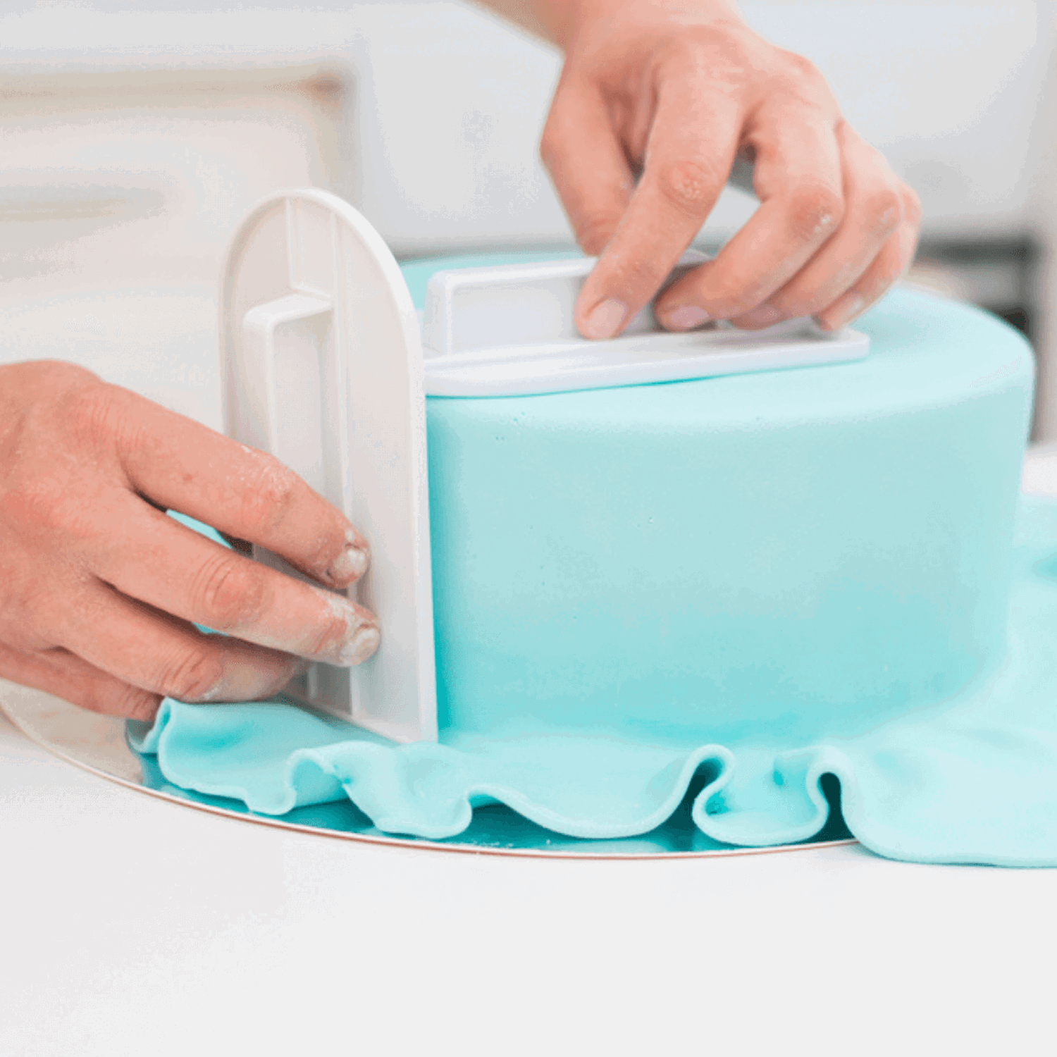 Person decorating a cake