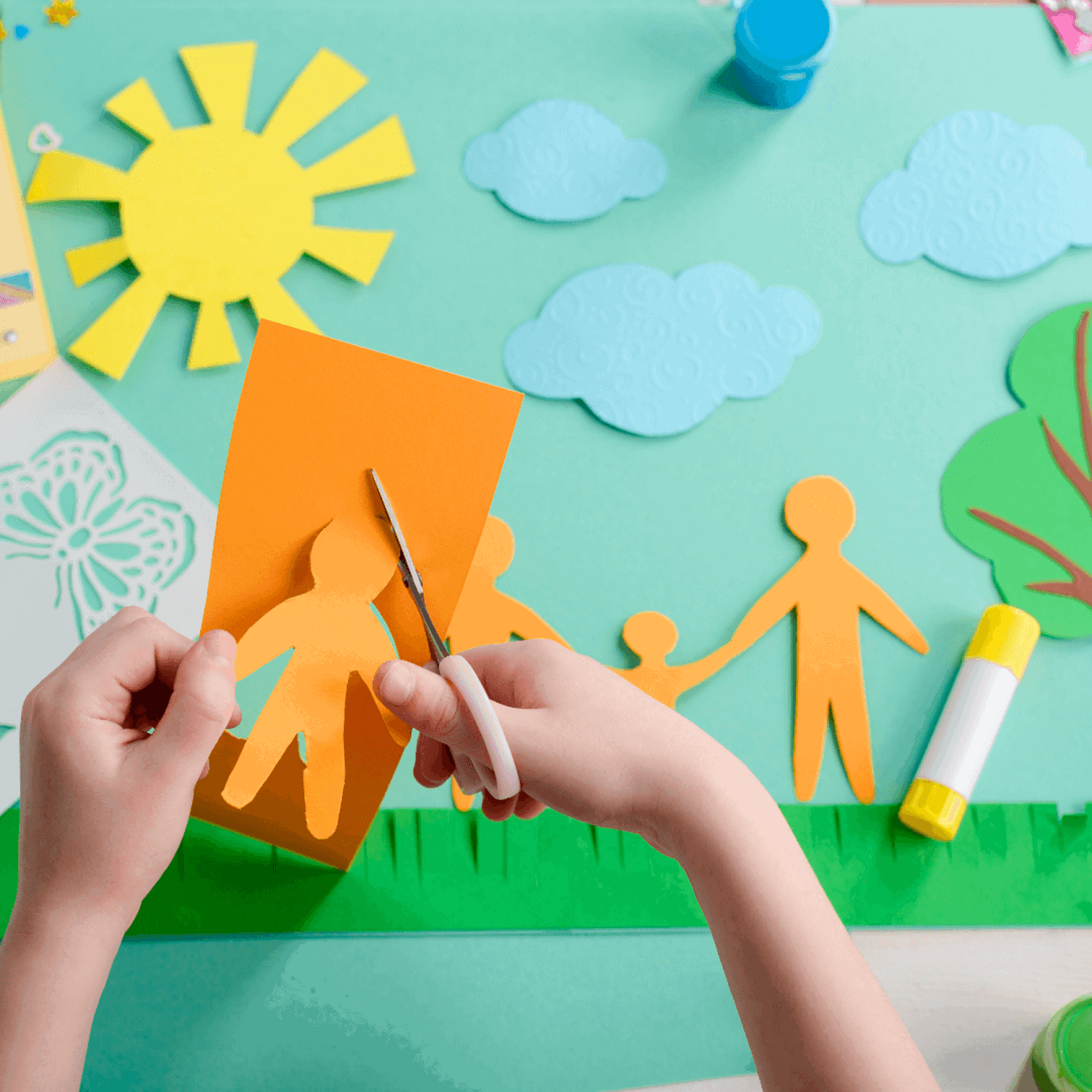 Child cutting out shape of person