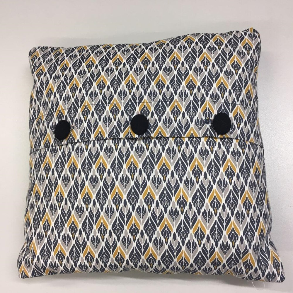 Patterned mustard and blue cushion