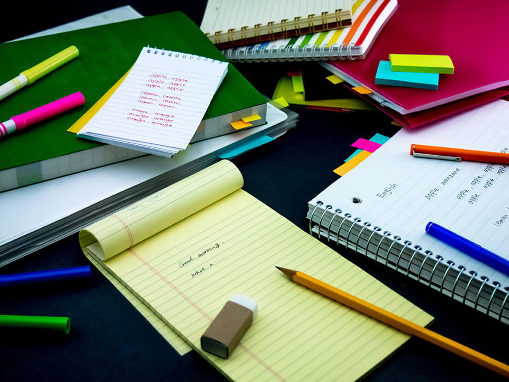 Pile of notebooks with English spellings written