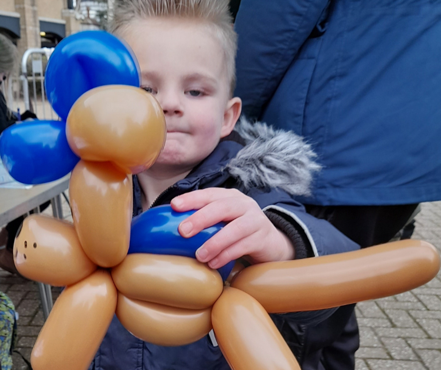 boy holding balloon animal