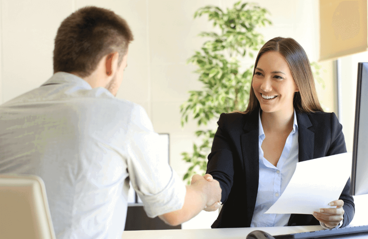 Girl shaking hands with man in interview 