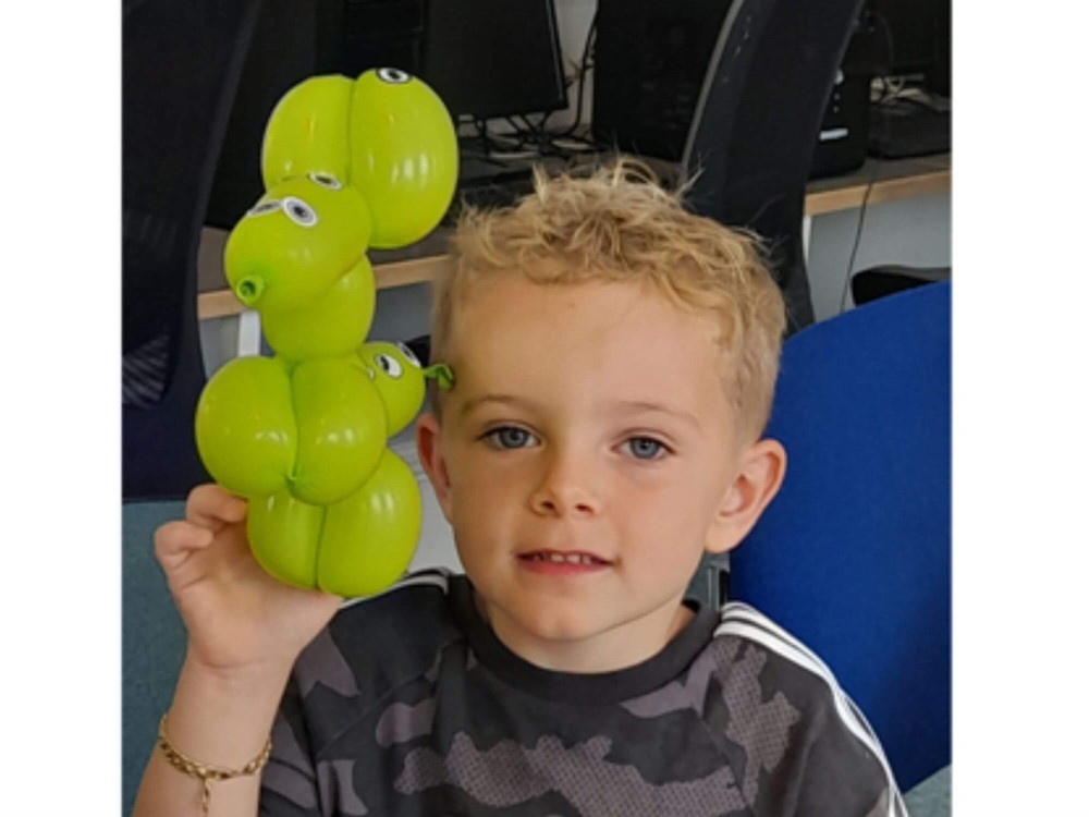 Boy holding balloon animal