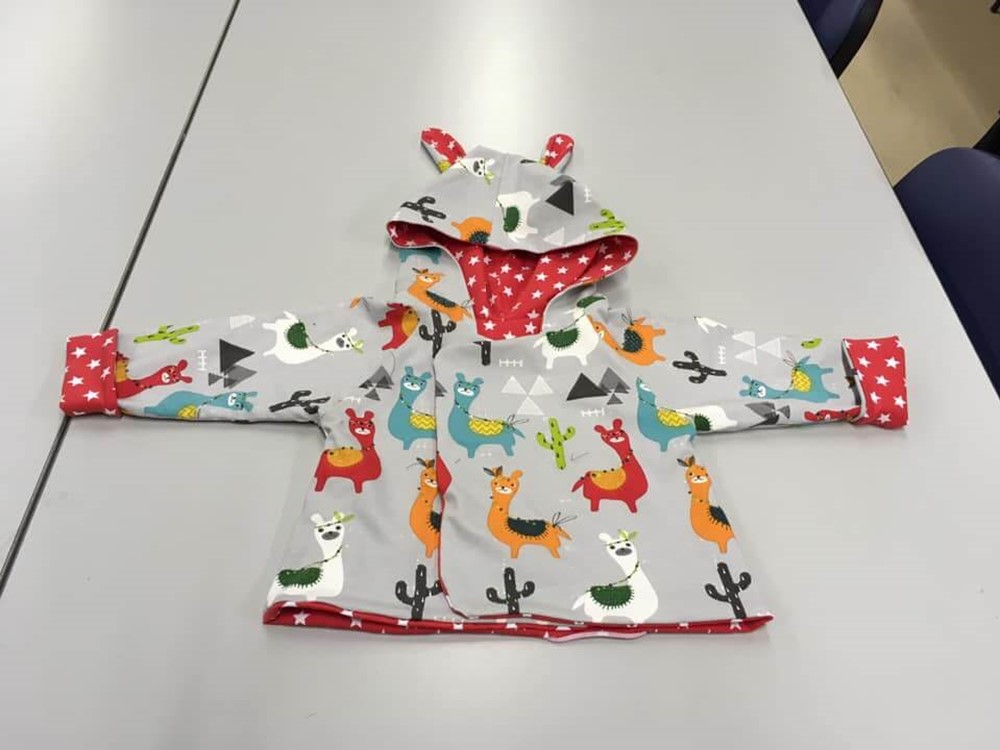 Children's coat with lama pattern