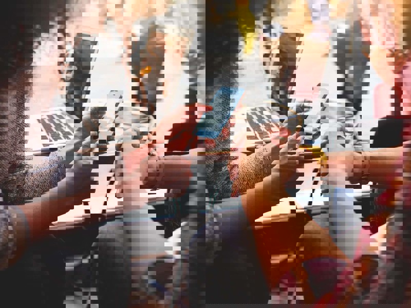 Two women looking at a mobile phone