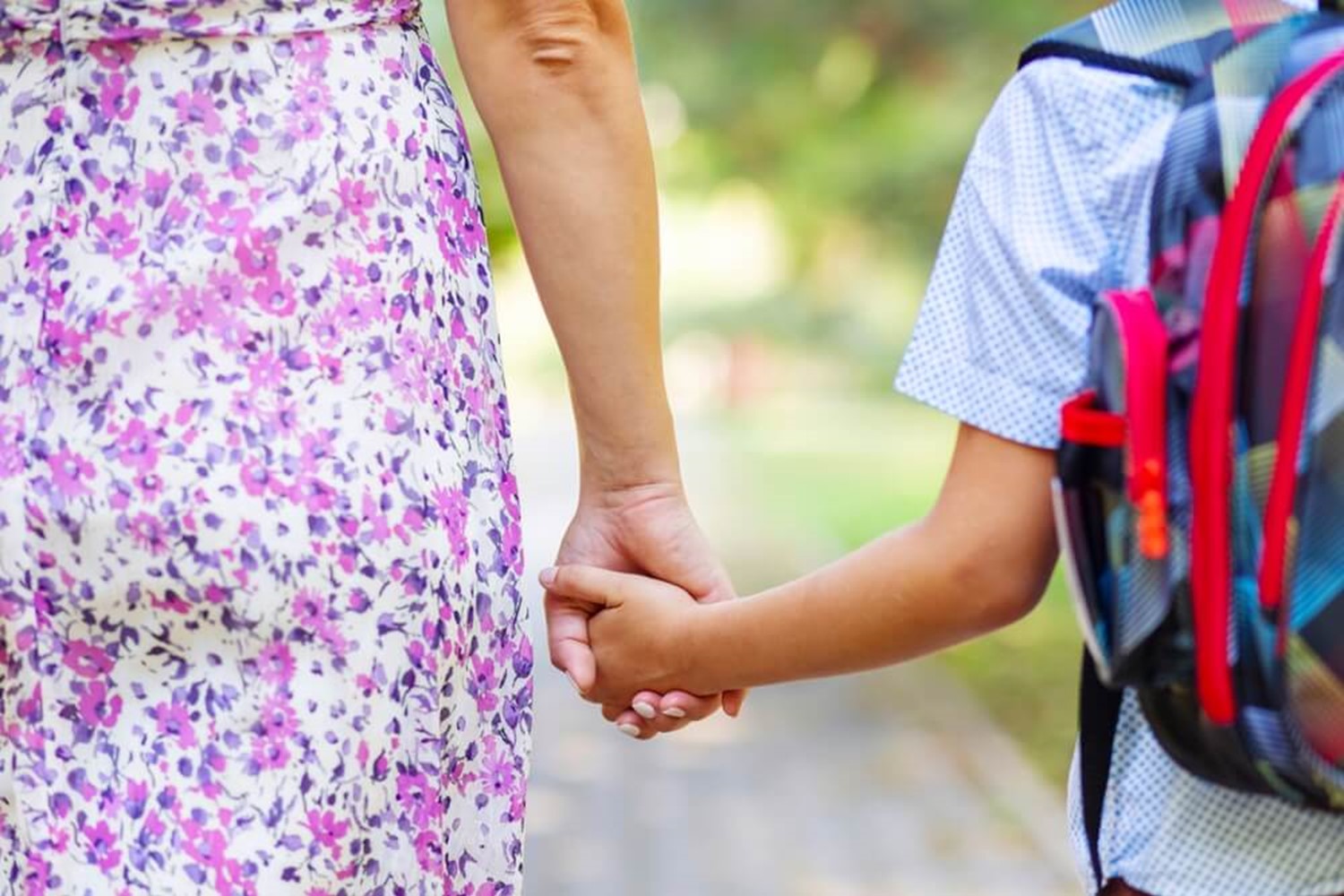 Mum and son holding hands