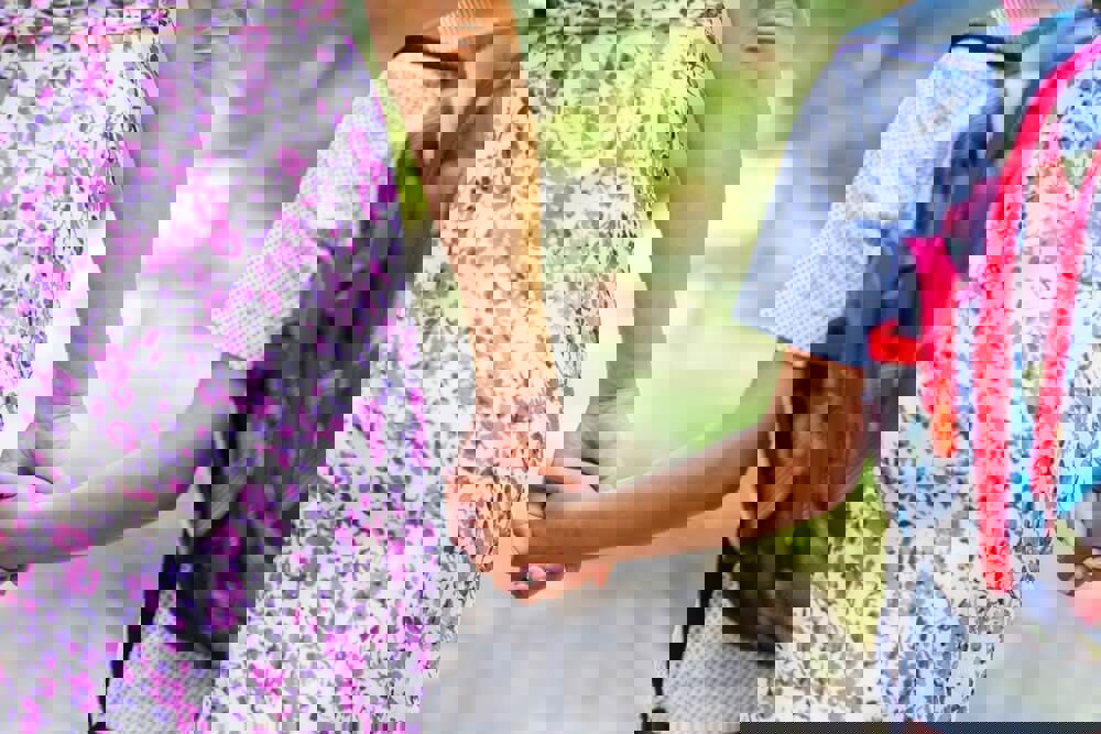 Mum and son holding hands