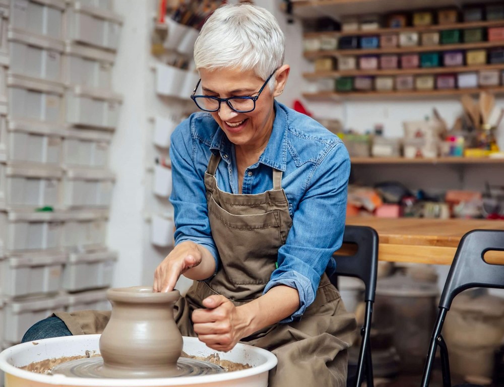 Lady using a pottery wheel